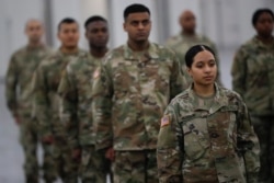 The National Guard stands in formation at the Jacob Javits Center, Monday, March 23, 2020, in New York.