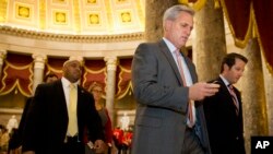 FILE - House Majority Leader Kevin McCarthy walks to a procedural vote and debate in the House on a stopgap spending bill to avert a government shutdown, Sept. 30, 2015.