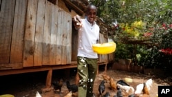 Bernard Mwololo feeds chickens at the Nyumbani Children's Home in Nairobi, Kenya, on Aug. 15, 2023. Benard, who has lived most of his life at the orphanage after his parents died of AIDS, believes he is alive only because of antiretroviral drugs made possible by U.S. assistance.