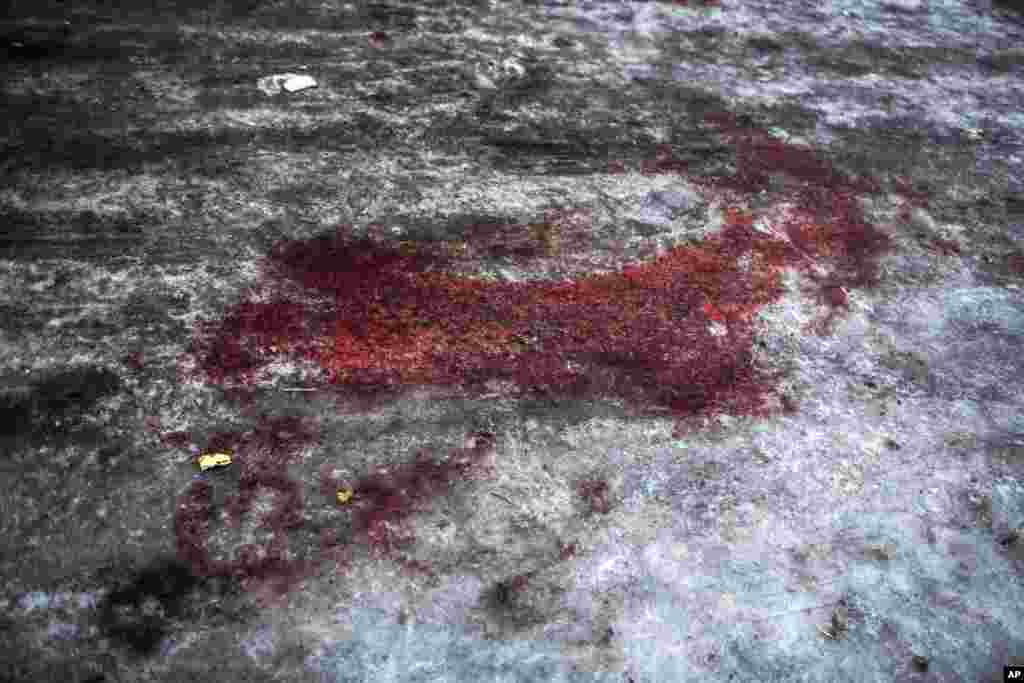 Blood from a Donetsk People&#39;s Republic soldier killed at the airport is seen at the gate of the morgue of Kalinisky Hospital, center of Donetsk, Ukraine, Jan. 18, 2015.