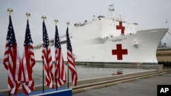 The U.S. Navy hospital ship USNS Comfort is docked at Naval Station Norfolk in Norfolk, Virginia, March 28, 2020. The ship is set to depart for New York to assist hospitals responding to the coronavirus outbreak. 