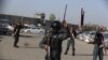 Security forces stand by after a suicide bomber detonated his payload near government offices in Kabul, Afghanistan, April 12, 2017. 