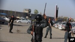 Security forces stand by after a suicide bomber detonated his payload near government offices in Kabul, Afghanistan, April 12, 2017. 