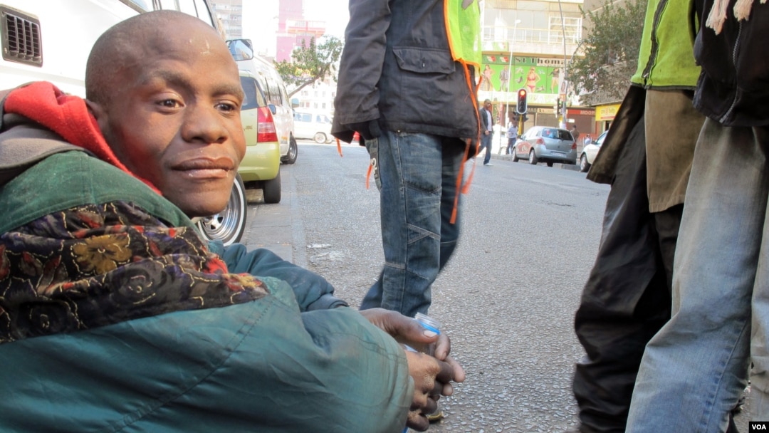 Buhlebezwe Mlambo is mentally ill and homeless. His friend Sello looks after him on the street, June 13, 2013 (G. Parker/VOA).