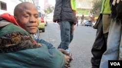 Buhlebezwe Mlambo is mentally ill and homeless. His friend Sello looks after him on the street, June 13, 2013 (G. Parker/VOA).