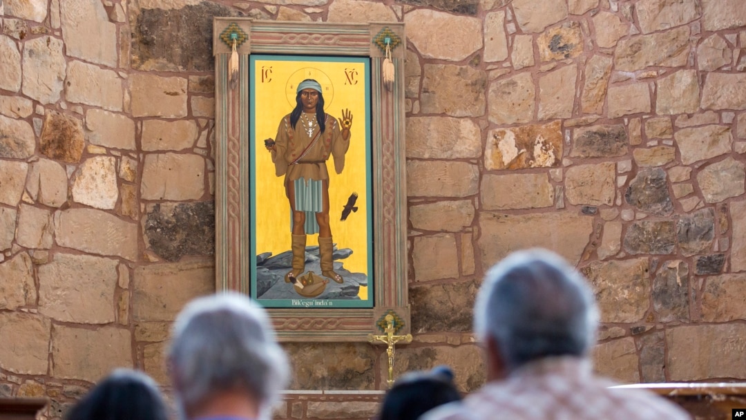 The Apache Christ painting hangs behind the altar of St. Joseph Apache Mission church in Mescalero, New Mexico, July 13, 2024. The painting was the forefront of an episode between the community and the local Diocese when it was removed by the church's then-priest.