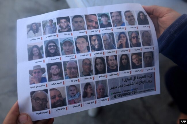 This photograph taken on Jan. 20, 2024, in Rafah, Gaza Strip, shows one of the leaflets dropped by Israeli forces over the city, showing portraits of Israeli hostages held in Gaza. It reads: