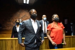 FILE - Self-proclaimed prophet Shepherd Bushiri and his wife Mary, right, attend a bail application in the magistrates court in Pretoria, South Africa, Oct. 30, 2020.