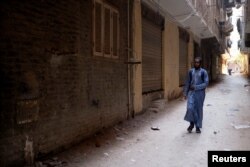 FILE - Barry walks on his way to the center where he studies Islam and the Koran, in El Marg district in the east of Cairo, Egypt, September 23, 2023.