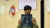 This photograph taken on November 4, 2024 shows patient Balram Kumar holding his chest x-ray at a special pollution clinic in the government-run Ram Manohar Lohia hospital of New Delhi.