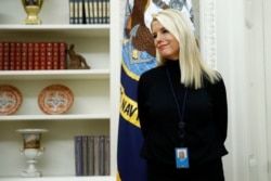 FILE - White House adviser Pam Bondi stands in the Oval Office as President Donald Trump participates in a bill signing ceremony for the Preventing Animal Cruelty and Torture Act, Nov. 25, 2019, in Washington.