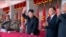  金正恩(中)2015年10月10日同刘云山(右二)一道观看朝鲜"劳动党"建党70周年阅兵式