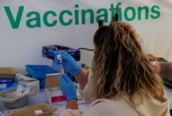 The AstraZeneca vaccine is prepared in the COVID-19 vaccination center at the Odeon Luxe Cinema in Maidstone, Britain, Feb. 10, 2021.