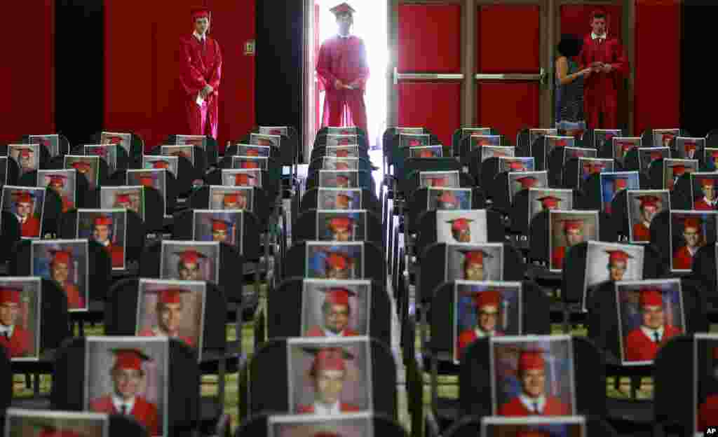 Graduating seniors of Brophy College Preparatory wait their turn to walk down the aisle to the stage individually during Diploma Days due to the coronavirus in Phoenix, Arizona, May 28, 2020.