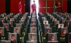 FILE - Graduating seniors of Brophy College Preparatory wait their turn to walk down the aisle to the stage individually during Diploma Days due to the coronavirus in Phoenix, Arizona, May 28, 2020.