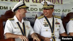 Philippine Navy Rear Admiral Leopoldo Alano (R) shares a light moment with U.S. Navy Rear Admiral William Merz during the opening ceremony of the Cooperation Afloat Readiness and Training (CARAT) 2015 at navy headquarters in Puerto Princesa city, Palawan on June 22, 2015