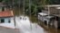 A group of men walk through a flooded road during a rescue mission in Nagoda village in Kalutara, Sri Lanka, May 29, 2017. 