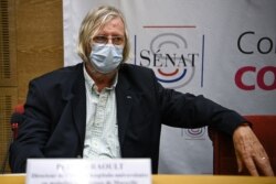 FILE - French medicine professor Didier Raoult wears a disposable face mask as he stands before a Senate commission on the management of the COVID19 pandemic by French State institutions on Sept. 5, 2020 in Paris.