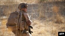 FILE - A soldier of the French Army monitors a rural area during the Barkhane operation in northern Burkina Faso on Nov. 10, 2019. 