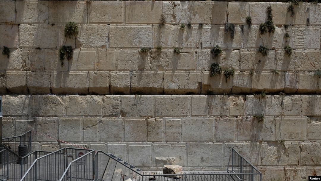 A stone that fell off the Western Wall in Jerusalem can be seen near the wall in Jerusalem's Old City, July 23, 2018. 