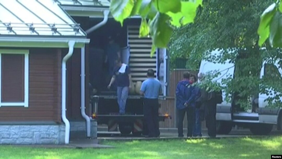 A still image taken from a video footage shows men loading a truck at a dacha compound used by U.S. diplomats for recreation, in Serebryany Bor residential area in the west of Moscow, Russia, Aug. 1, 2017.