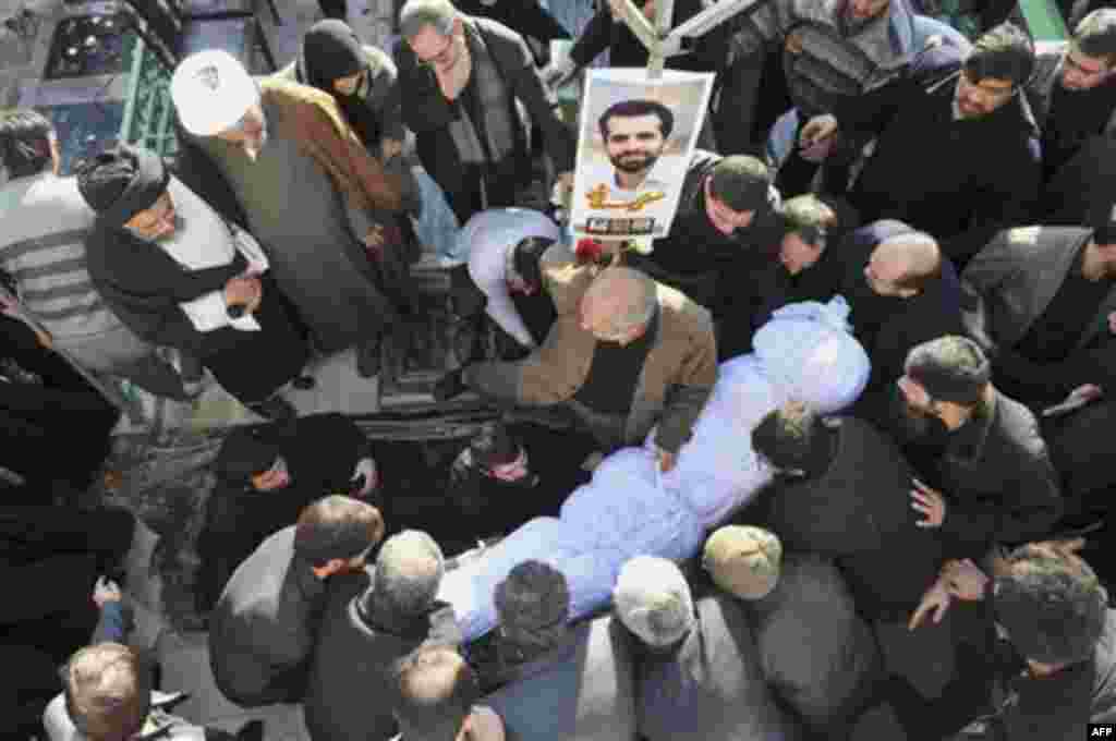 The shrouded body of Mostafa Ahmadi Roshan, a chemistry expert and a director of the Natanz uranium enrichment facility in central Iran, who was killed in a brazen daylight assassination when two assailants on a motorcycle attached a magnetic bomb to his 