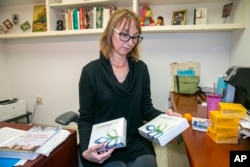 Lauren Gilbert, Center for Jewish History, Senior Manager for Public Services, in New York City Tuesday, November 29, 2022, handles Ancestry DNA test kits the center offers free to Holocaust survivors. (AP Photo/Ted Shaffrey)