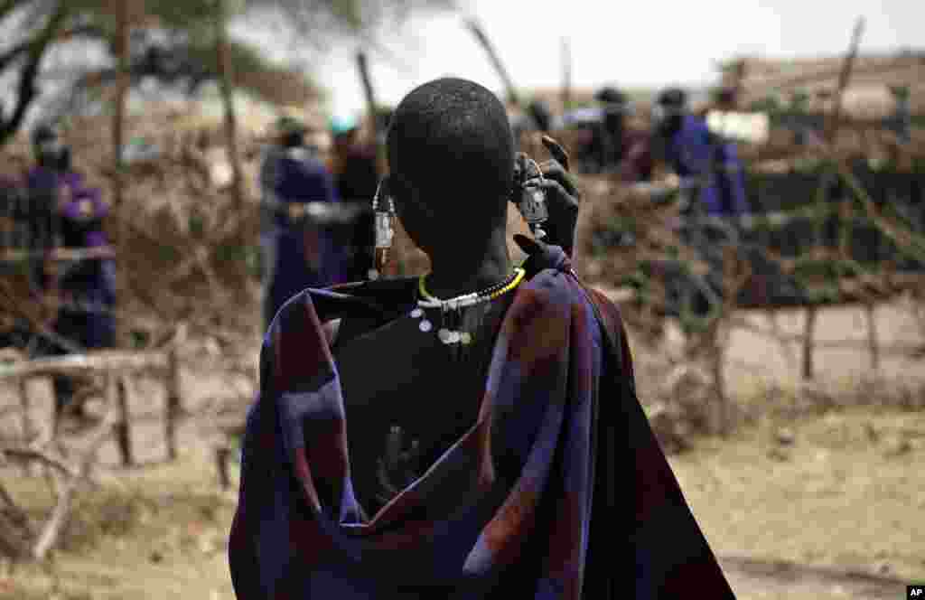 Une&nbsp;Maasai porte son bébé sur son dos dans un village à la périphérie de Serengeti, dans le nord de la Tanzanie, le 12 août 2013.