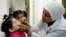 FILE - A health worker administers polio vaccine to a child as part of a UNICEF-supported vaccination campaign at the Abou Dhar Al Ghifari Primary Health Care Center in Damascus, Syria, Oct. 29, 2013.