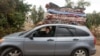 Displaced Lebanese Assaad Bzih is pictured in his car with belongings on top near his home, after a ceasefire between Israel and Hezbollah took effect, in Zibqin