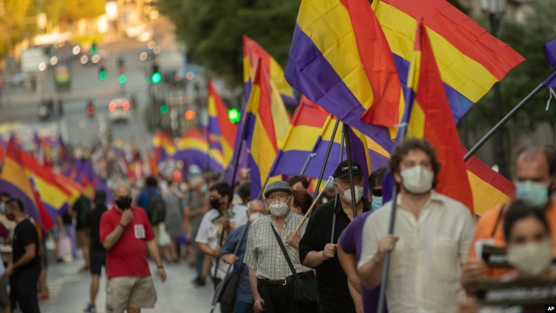 Demonstrators holding Republican flags march during a protest against the Spanish monarchy in Madrid, Spain, July 25, 2020. 