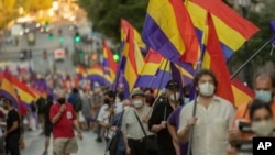 FILE - Demonstrators holding a Republican flag march during a protest against Spanish Monarchy in Madrid, Spain, July 25, 2020.