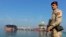 FILE - An Iraqi soldier stands guard near the Central Metering and Manifold platform at Al Basra oil terminal in the Persian Gulf, November 2013.