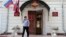An officer walks outside a Federal Migration Service office in central Moscow, July 16, 2013.