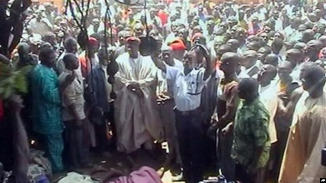 In this image taken from TV showing the bodies of victims of inter-faith violence as a crowd gathers around, in the town of Dogo Nahawa, Nigeria, south of the city of Jos (File Photo)