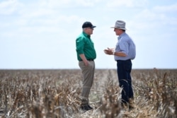 FILE - Australian Prime Minister Scott Morrison, left, chats with farmer David Gooding on his drought-affected property near Dalby, Queensland, Australia, Sept. 27, 2019.