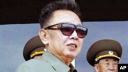 An undated file photo of N. Korean leader Kim Jong-Il (L) inspecting Combined Unit 597 of the Korean People's Army Navy and combined maneuvers at undisclosed location