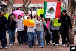 Orange County Educational Arts Academy students, escorted by teachers, protest President Donald Trump's immigration policy outside U.S. District Court in Santa Ana, Calif., Feb. 6, 2025.