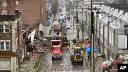 Emergency responders and heavy equipment are seen at the site of a deadly explosion at a chocolate factory in West Reading, Pennsylvania, March 25.