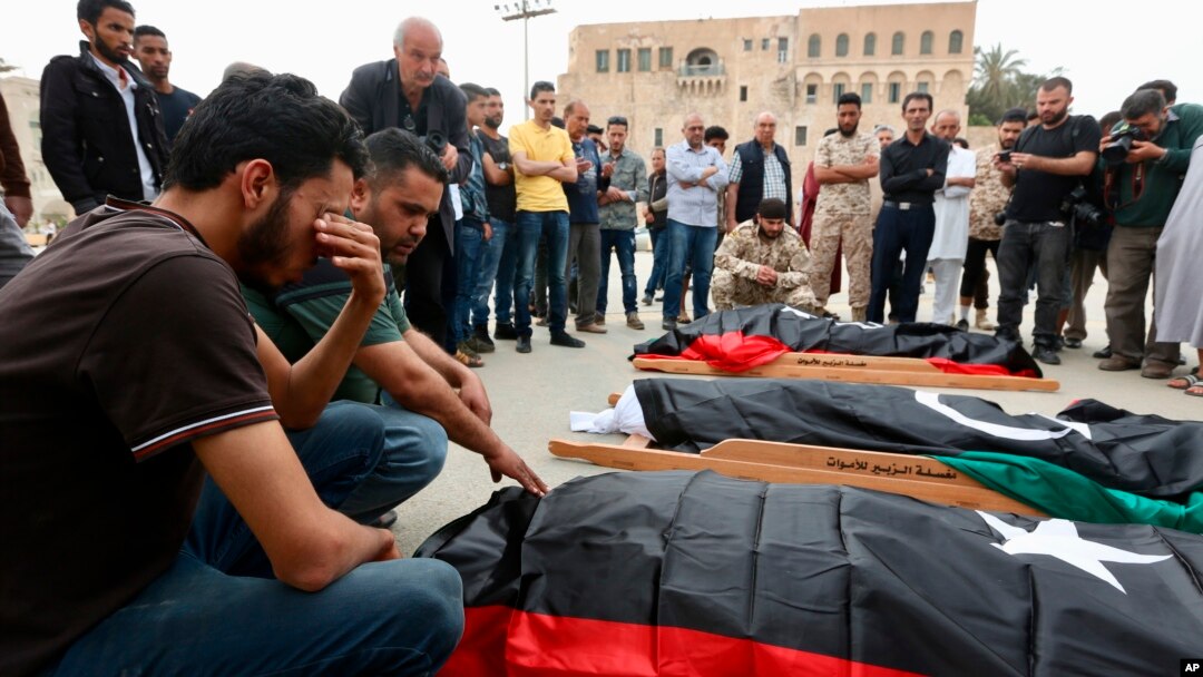 FILE - Mourners gather for funeral prayers for fighters killed by warplanes of Field Marshal Khalifa Hifter's forces, April 24, 2019, in Tripoli, Libya.