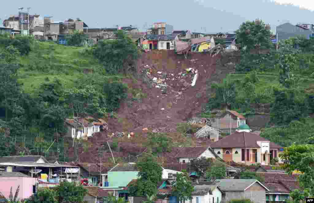 This general view shows the side of a hill which collapsed and swept away homes in Sumedang, West Java province after landslides killed at least 11 people and left scores more missing.