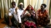 FILE - Newly-wedded Nubian couple, Bashir Ibrahim (2nd L) and Zubeda Mohamed Ahmed (2nd R), wait to receive gifts, seven days after their wedding in accordance with Nubian culture, in their house at Makina village in Nairobi's Kibera slum.