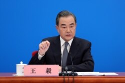 Chinese Foreign Minister Wang Yi speaks to reporters via video link at a news conference held on the sidelines of the National People's Congress (NPC), from the Great Hall of the People in Beijing, China, May 24, 2020.