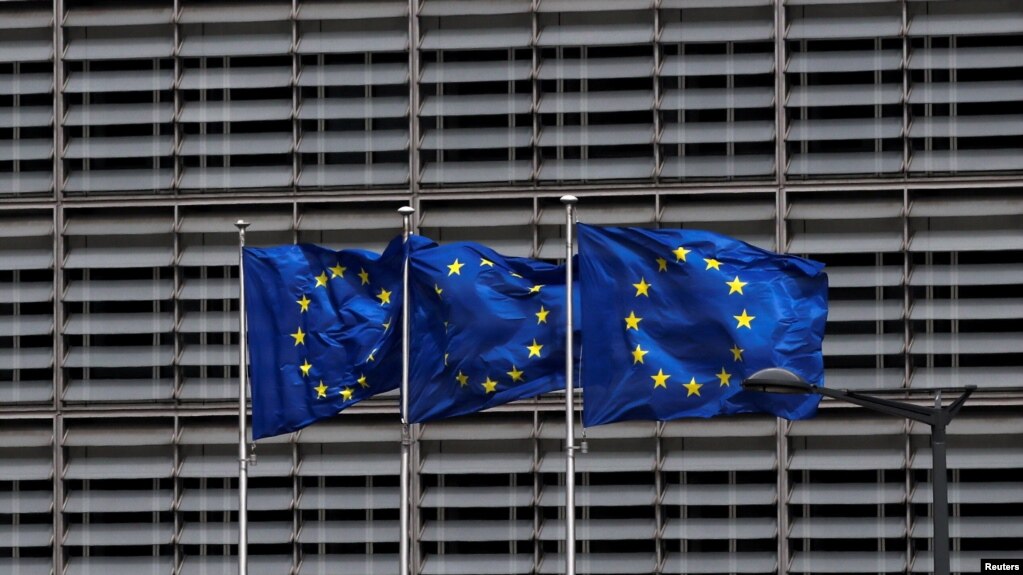 FILE - European Union flags flutter outside the EU Commission headquarters in Brussels, Belgium, May 5, 2021. 