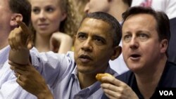 Presiden AS Barack Obama dan tamunya, PM Inggris David Cameron menonton pertandingan bola basket perguruan tinggi AS di Ohio (13/3).