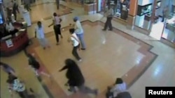 FILE - Shoppers flee during an attack by gunmen, inside the Westgate shopping mall in this still frame taken from video footage by security cameras inside the mall in Nairobi, Kenya, released on Oct. 17, 2013.