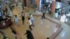 FILE - Shoppers flee during an attack by gunmen, inside the Westgate shopping mall in this still frame taken from video footage by security cameras inside the mall in Nairobi, Kenya, released on Oct. 17, 2013.