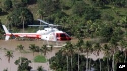 A handout picture released by Alagoas Agency on June 21, 2010 shows a fire brigade helicopter fliying over Rio Largo, Alagoas State, northeastern Brazil, looking for victims following the overflowing of the Mandau river on 20 June 2010