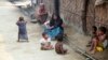 Rohingya Muslims sit on the ground at Da Paing camp for Muslim refugees in north of Sittwe, Rakhine State, western Myanmar, April 2, 2014. 