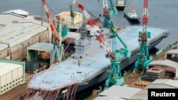 FILE - An aerial view of Japan Maritime Self-Defense Force's new helicopter destroyer, DDH183 Izumo, is seen at its launching ceremony in Yokohama, south of Tokyo, in this photo taken by Kyodo August 6, 2013. 